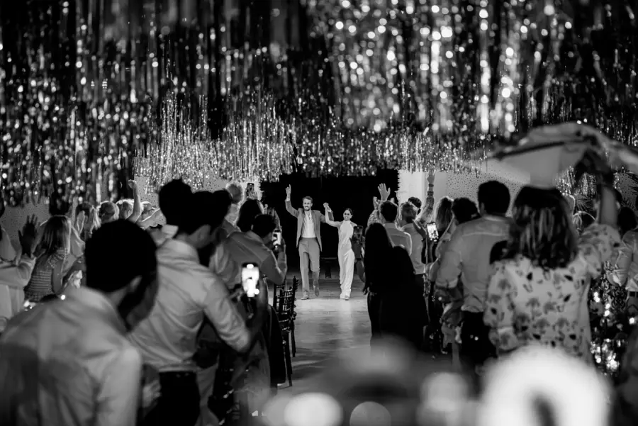 Black and white grand entrance beneath a shimmering tinsel canopy - wedding photographer Marrakech